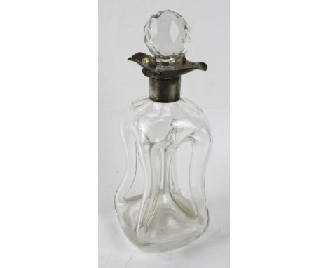 A late Victorian silver collared decanterOf hourglass form, the clear glass decanter with silver wavy collar and later stoppe