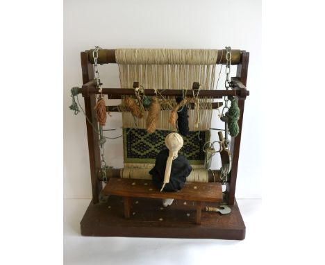 An Indian model of a rug loom, mid 20th CenturyThe hardwood frame and bench with inlaid bone floral decoration, Indian figure