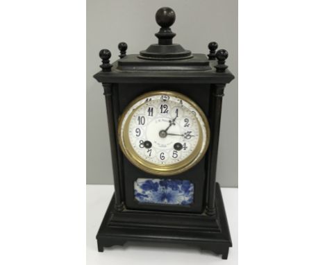 A late 19th Century JW Benson of London mantle clock with bronzed architectural case, the white enamel dial set with blue Ara