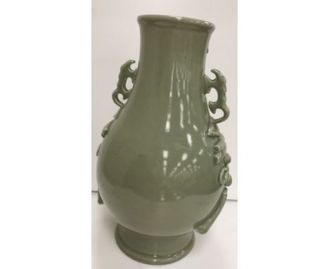 A Chinese celadon glazed vase bearing faux six character Chenghua (1465-87) mark to base, raised on a wooden base, 39 cm high