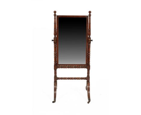 A Regency mahogany cheval mirror, the rectangular swing mirror plate between tapering ring turned and ball finial uprights, t