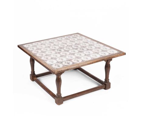 A low table with Dutch Delft tile top, the forty-nine tiles each of flower vase design on turned legs united by stretchers, 1