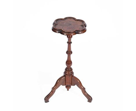 An early 18th Century style walnut candle stand, with lobed top on turned column and tripod base, 64.5cm high