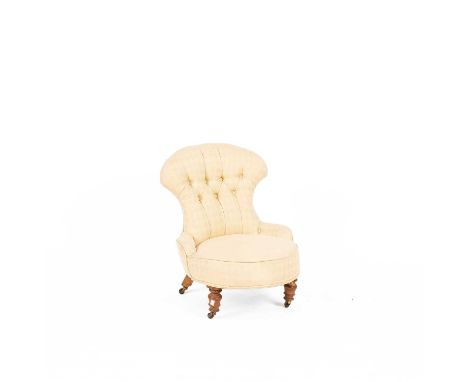 A Victorian beech framed nursing chair, the button upholstered back above a circular seat, on turned tapering legs with brass