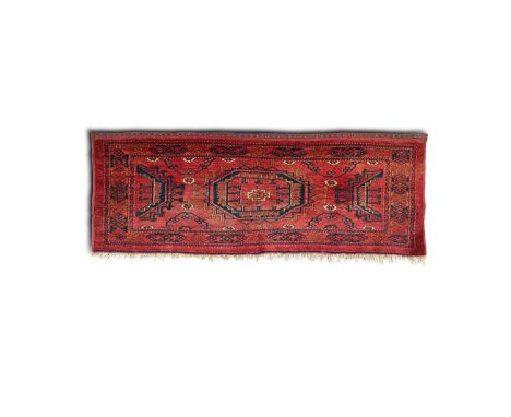 An Ersari Torba, Afghanistan, circa 1920, the pale wine red field of bold Salor guls, framed by a hooked motif border and a f
