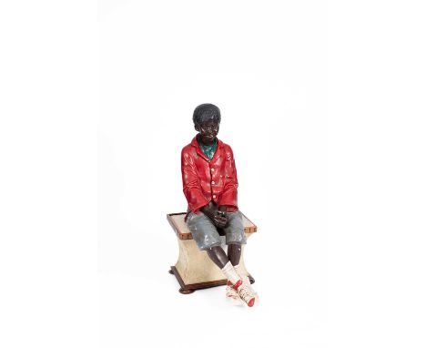 A Goldscheider type figure of a sitting boy, wearing a red coat and grey shorts, 115cm high