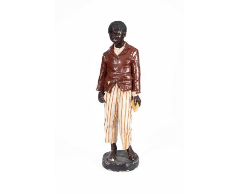A Goldscheider type figure of a standing boy, wearing brown coat and striped trousers, 148cm high