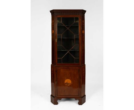 An Edwardian mahogany and marquetry corner cupboard, with a moulded cornice above an astragal glazed door enclosing shaped sh