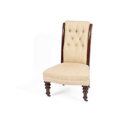 A Victorian mahogany framed nursing chair, with button back on turned front legs with white ceramic castors and an inlaid ova