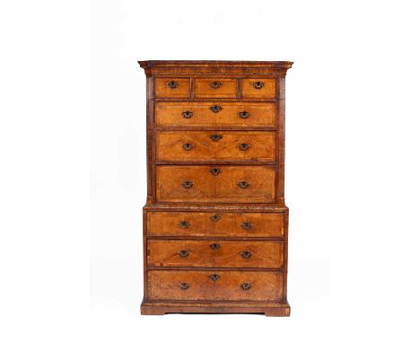 A George II walnut and feather banded secretaire chest on chest, the upper section fitted with three short over three long dr
