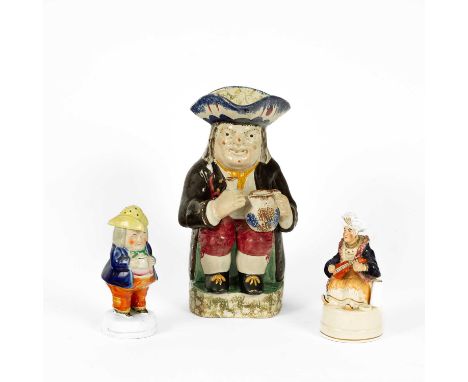 A traditional Staffordshire pearlware Toby jug, 26cm high, a figure of a Turk holding a violin, 14cm high and a figural peppe