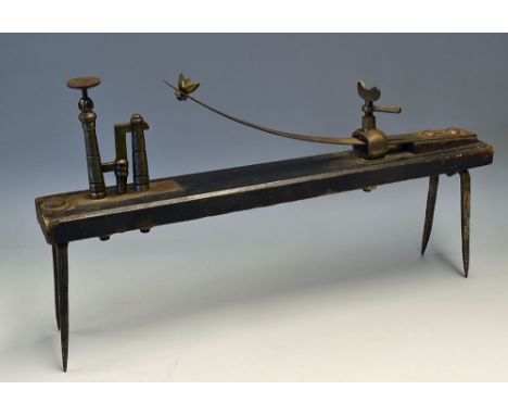 Interesting Knur and Spell Game a horizontal wooden plank with attached iron spikes and a spring loaded contraption, the Spel