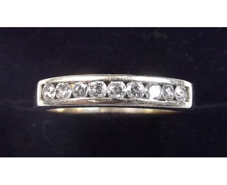 A 9ct half eternity ring with channel diamonds, size O