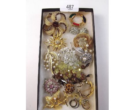 A box of vintage costume brooches