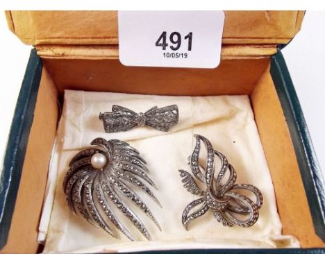 Two vintage silver marcasite brooches and a bow form one