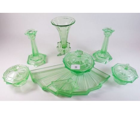 A vintage green glass dressing table set