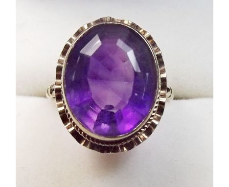 A 9 carat gold ring set oval cut amethyst size J