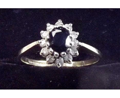 A 9 carat gold sapphire and diamond cluster ring - size M