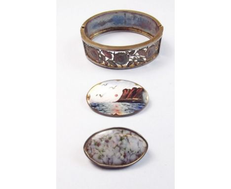 A single hinged bangle and two silver brooches