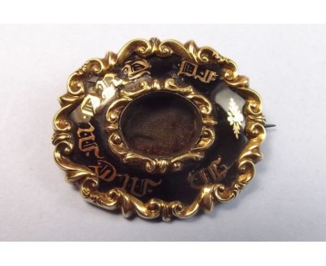 A Victorian 9 carat gold and black enamel mourning brooch, centre panel missing
