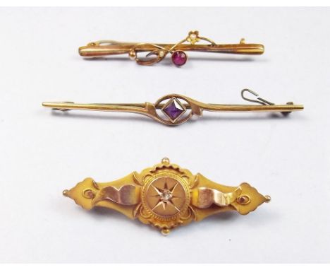 A Victorian 9 carat gold brooch set diamond, a 9 carat gold bar brooch set amethyst and another set red stone