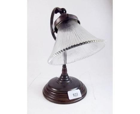 An early 20th century table lamp with curved adjustable stem and prismatic glass shade