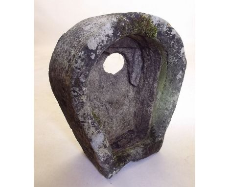 A small antique stone trough in the shape of a horse shoe, 62 cm long