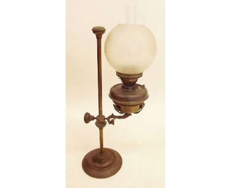 A Victorian brass oil lamp with adjustable height stem