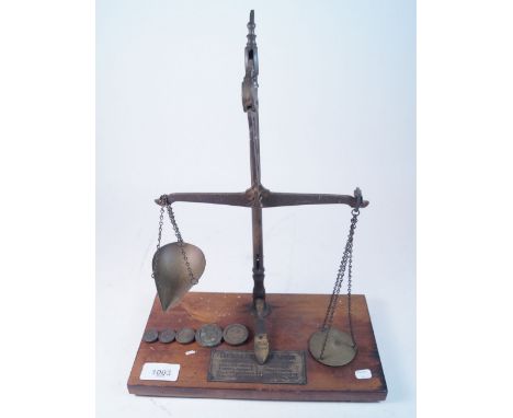 A pair of Curtis &amp; Harvey gunpowder brass weighing scales on wooden base with measures and scale to plaque