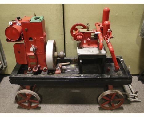 A vintage Lister 'D' stationary engine on a trolley. No. 1/55388 with a vintage Climax water pump. On a stand, H78cm.