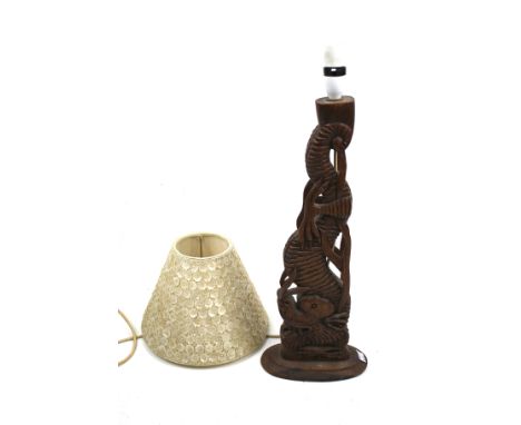 A carved teak Chinese dragon lamp base. With a mother of pearl decorated shade. H49cm