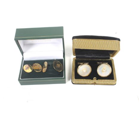 Two pairs of cufflinks, comprising a pair of silver-gilt oval twin-panel cufflinks with chain inter-links, one panel of each 