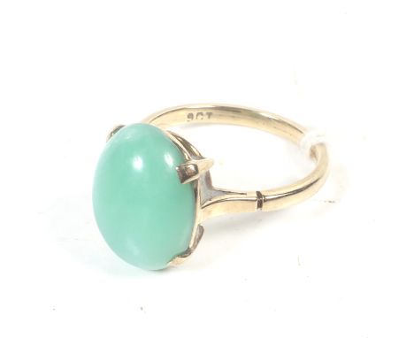 A mid 20th century gold and oval cabochon green chalcedony single stone ring. The stone claw set on a D-section shank stamped