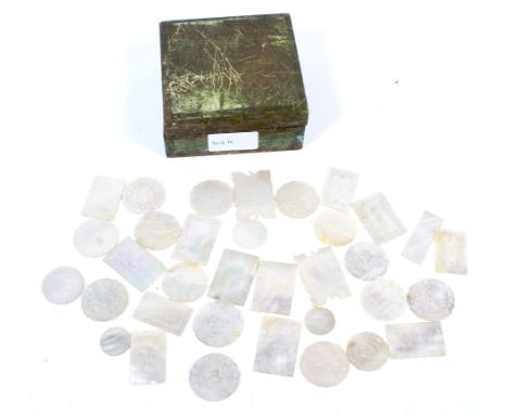 A vintage box of 19th century and later Chinese carved mother of pearl antique chips or gaming counters