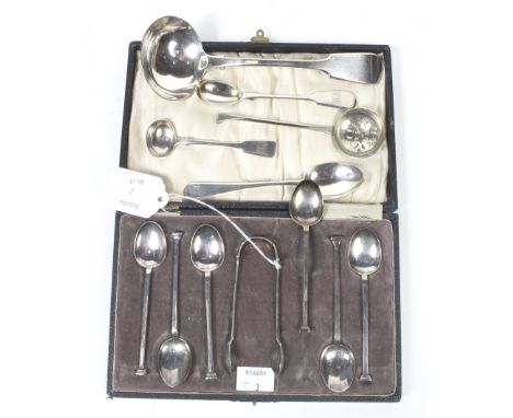 A set of six 20th century silver seal top coffee spoons and a sugar tongs. Birmingham 1921, 86g; in a fitted case; together w