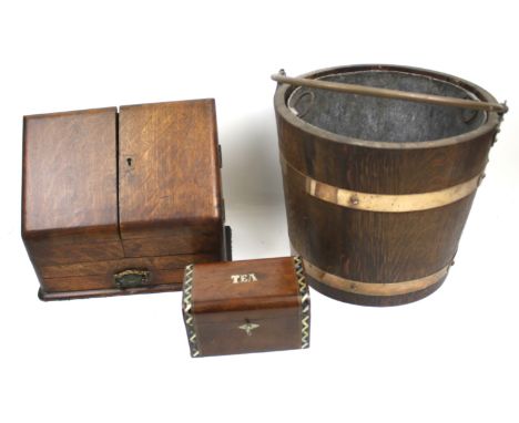 A collection of three vintage wooden items. Including an oak stationery box, a coopered coal bucket by Lister & Co, and a mot
