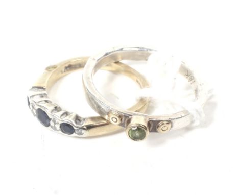 A vintage 9ct gold, sapphire and diamond ring and a silver and peridot ring. The three graduated round mixed-cut dark-blue/bl