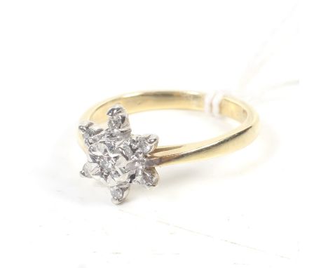 A vintage diamond seven stone 'star' cluster ring. The eight-cut stones illusion set in white on a yellow D-section shank sta