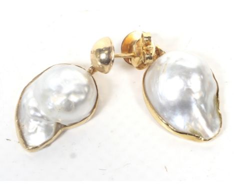 A pair of baroque cultured-blister-pearl pendent earrings. The boteh-shaped 'pearls' each rub-over set in unmarked yellow met