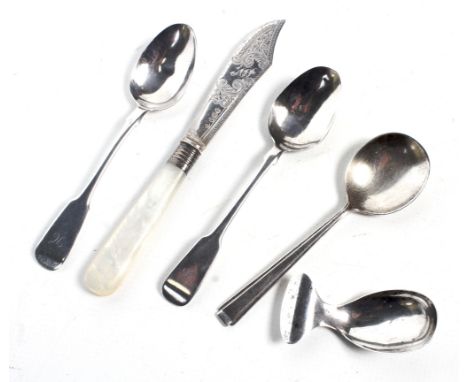 A small collection of silver including an oval caddy spoon, a Victorian butter knife and three teaspoons. The caddy spoon wit