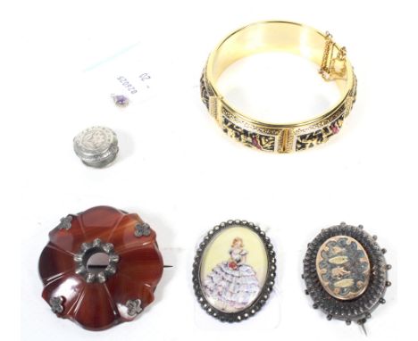 A small collection of jewellery including a mid-20th century silver and marcasite oval brooch. The glazed brooch enclosing a 