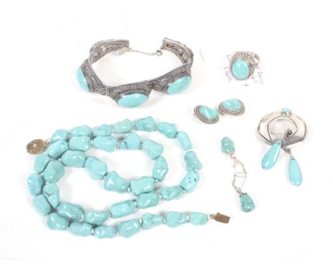 A collection of turquoise jewellery including a far eastern oval cabochon three stone panel bracelet; a similar single stone 