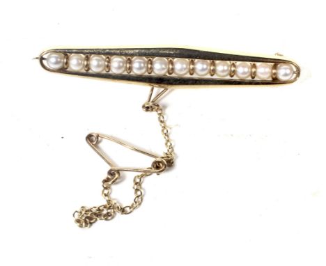 A vintage 9ct gold and cultured-pearl open bar brooch. The 12 3.5mm diameter cultured-pearls strung within an open surround a