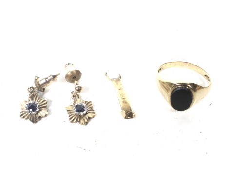 A vintage 9ct gold and black onyx oval signet ring and a pair of earrings. The signet ring with obscured hallmarks probably L