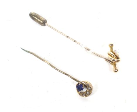 Two late Victorian/Edwardian gold and gem set stick pins. One with a bar and knot terminal set with a small round cabochon wh