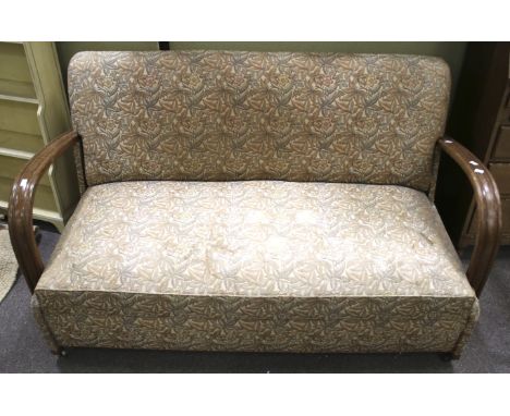 An Art Deco 1930s two seater sofa bed. AG &amp; T Blue Ribbon 'PUT U UP'. With open wooden arms, upholstered in floral fabric