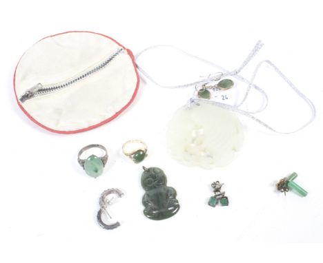 A collection of green hardstone jewellery including a New Zealand nephrite Hei Tiki pendant, an oval cabochon single stone ri