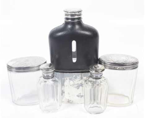 A plated hip flask, a silver mounted dressing table jar and various dressing table bottles. Comprising; a leather mounted cle