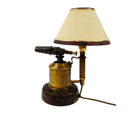 A Max Sievert APM brass blow torch table lamp, raised on a carved circular base, with shade, 33cm high.