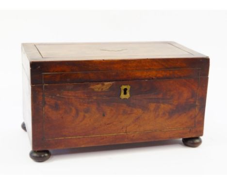 A Victorian mahogany and brass inlaid tea caddy, of rectangular form, opening to reveal two boxes flanking a central mixing b